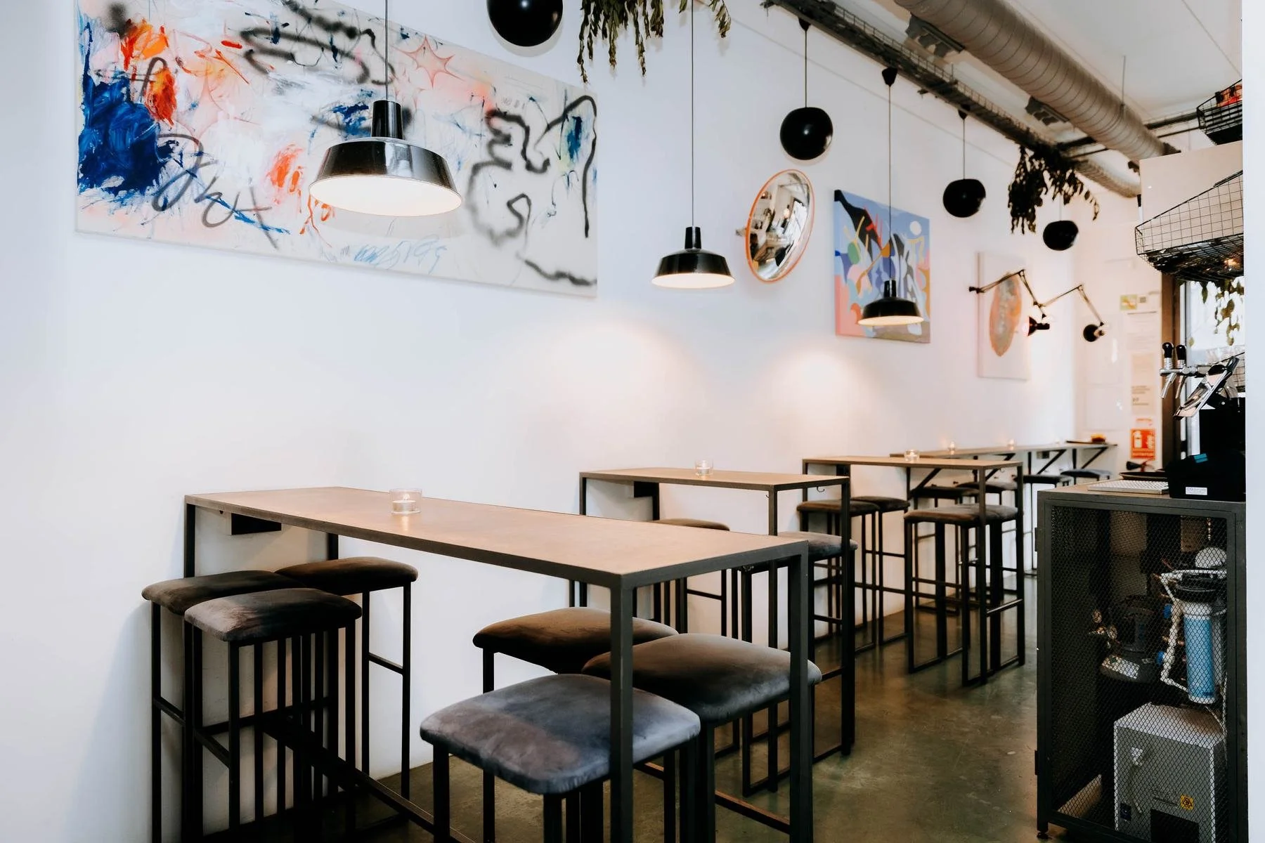 FOCO by day: white walls, big artwork and high tables.