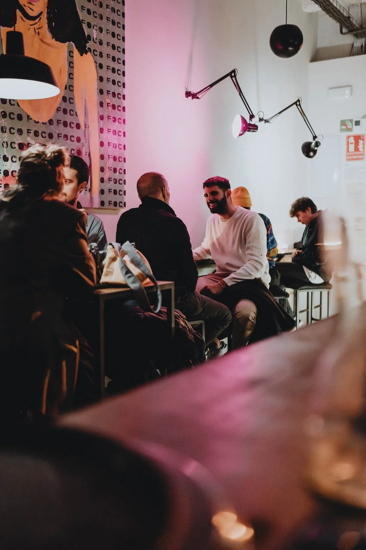 FOCO at night: low pink light and a full room.