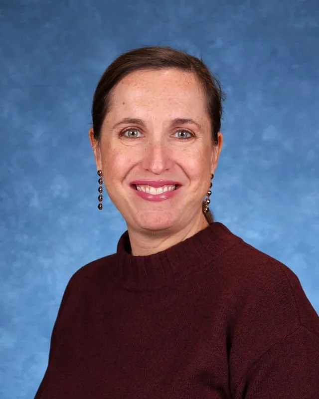 Portrait of Myrna Gonzalez Rojas, Principal/Directora, smiling against a neutral background.