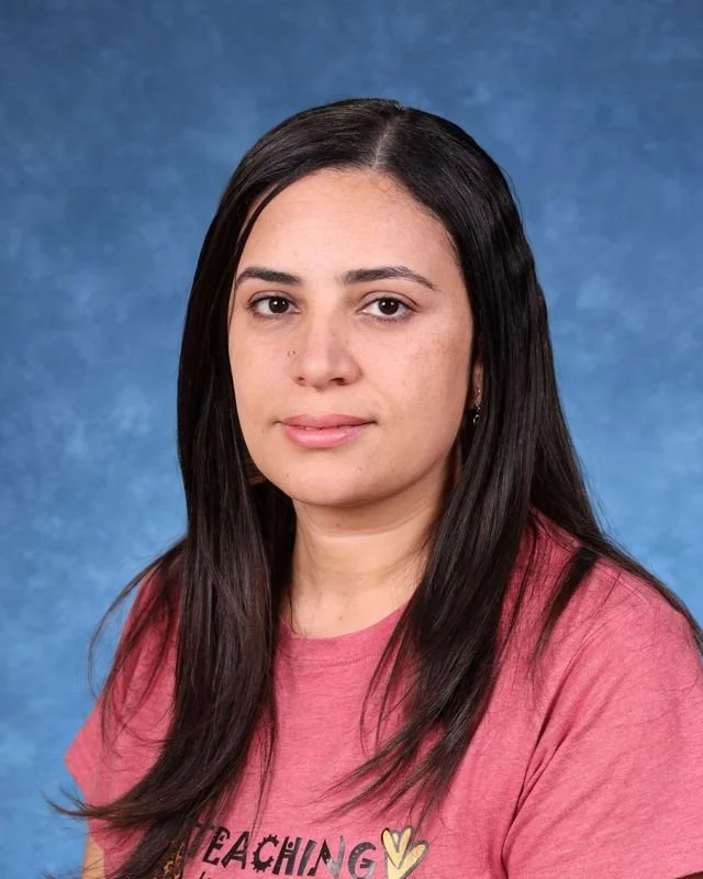 Headshot of Shehata, with a professional demeanor.