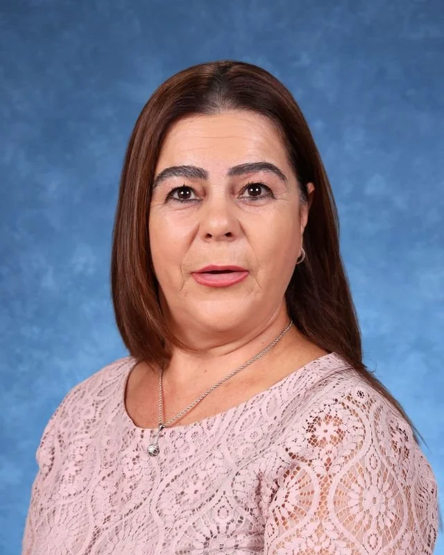 Portrait of Myrna Gonzalez Rojas, Principal/Directora, smiling against a neutral background.