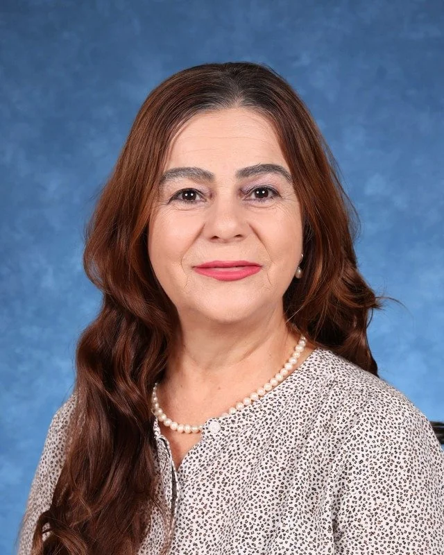 Portrait of Myrna Gonzalez Rojas, Principal/Directora, smiling against a neutral background.