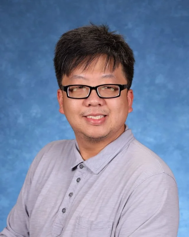 Photograph ofD. Hong, posing formally.