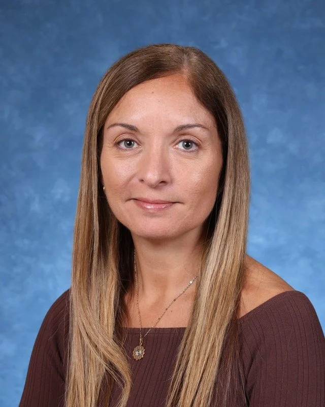 Portrait of Myrna Gonzalez Rojas, Principal/Directora, smiling against a neutral background.