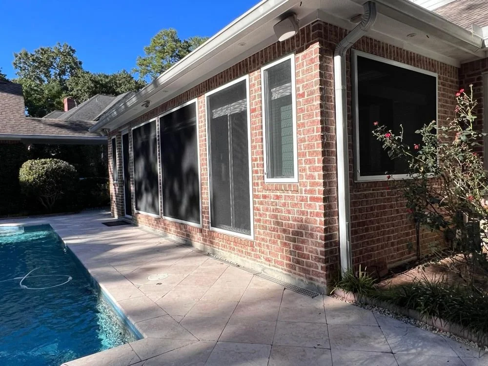 Security screens on poolside windows of a Houston home