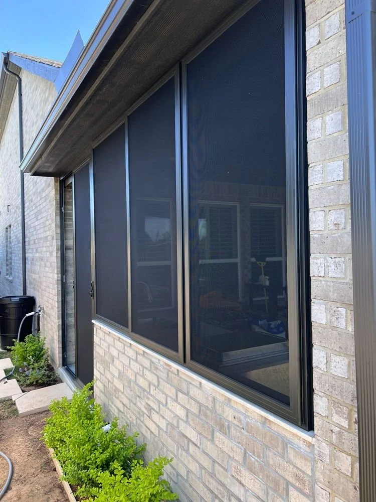Window security screens on a brick home in Houston