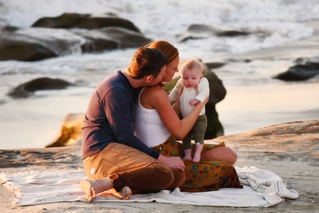 Family together beside the ocean