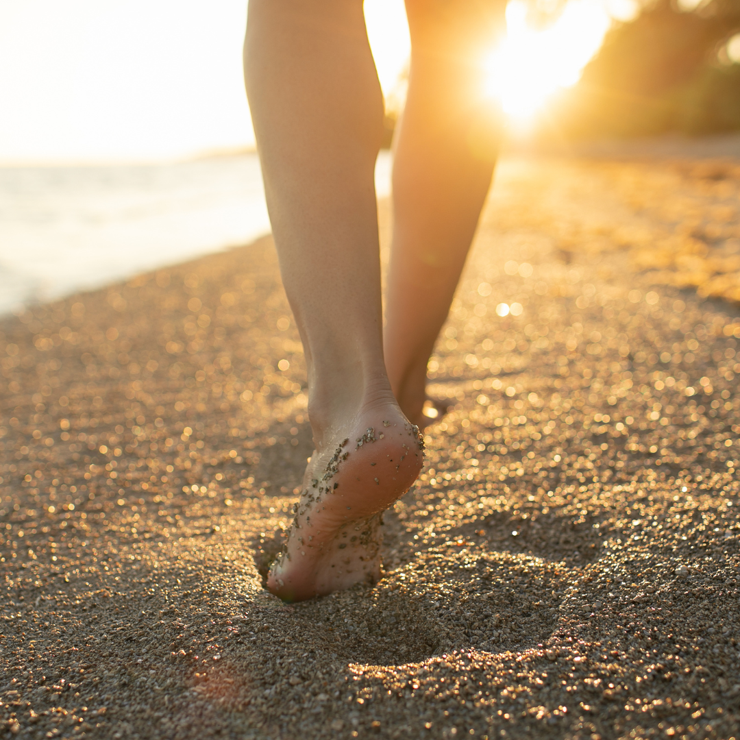 Bare feet walking on sand