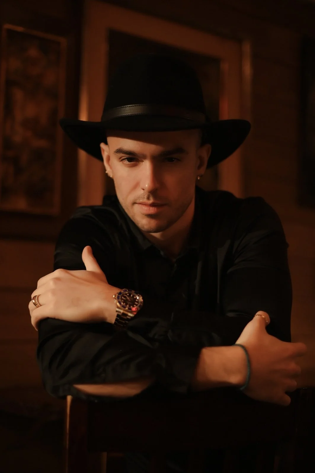 Warmly lit portrait of Panas in a hat