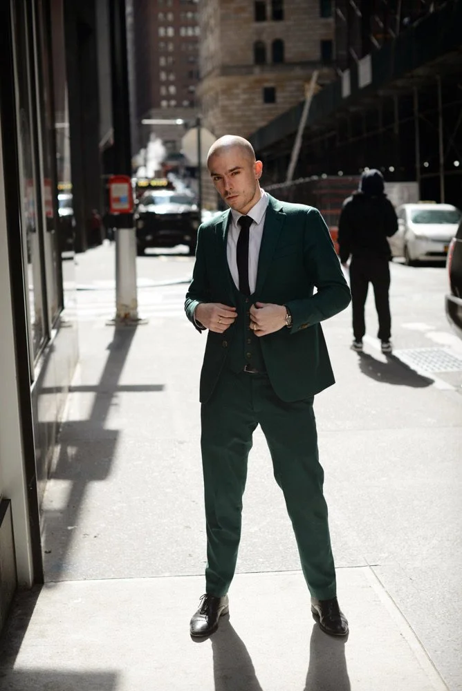 Panas in a green suit on a New York street