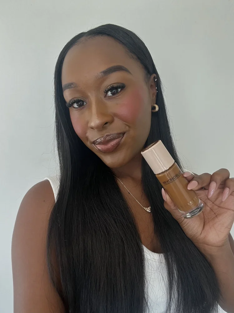 A creator holding BeyondBlur foundation and a foundation brush