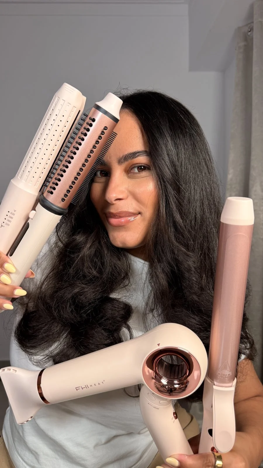 A creator holding a set of hair styling tools