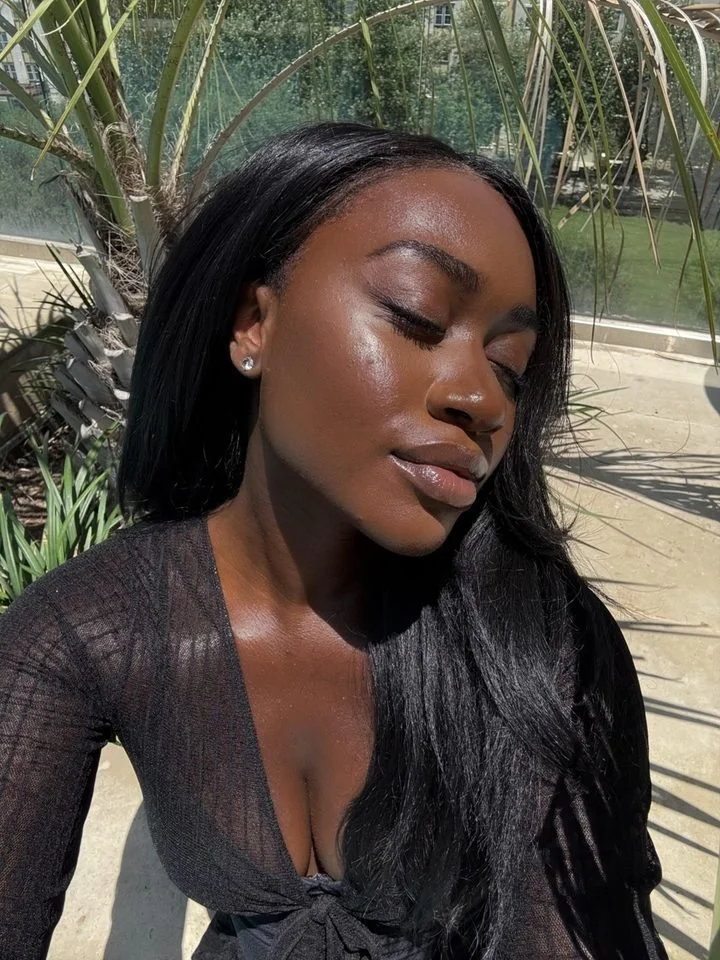 A sunlit creator with glowing skin, palms behind