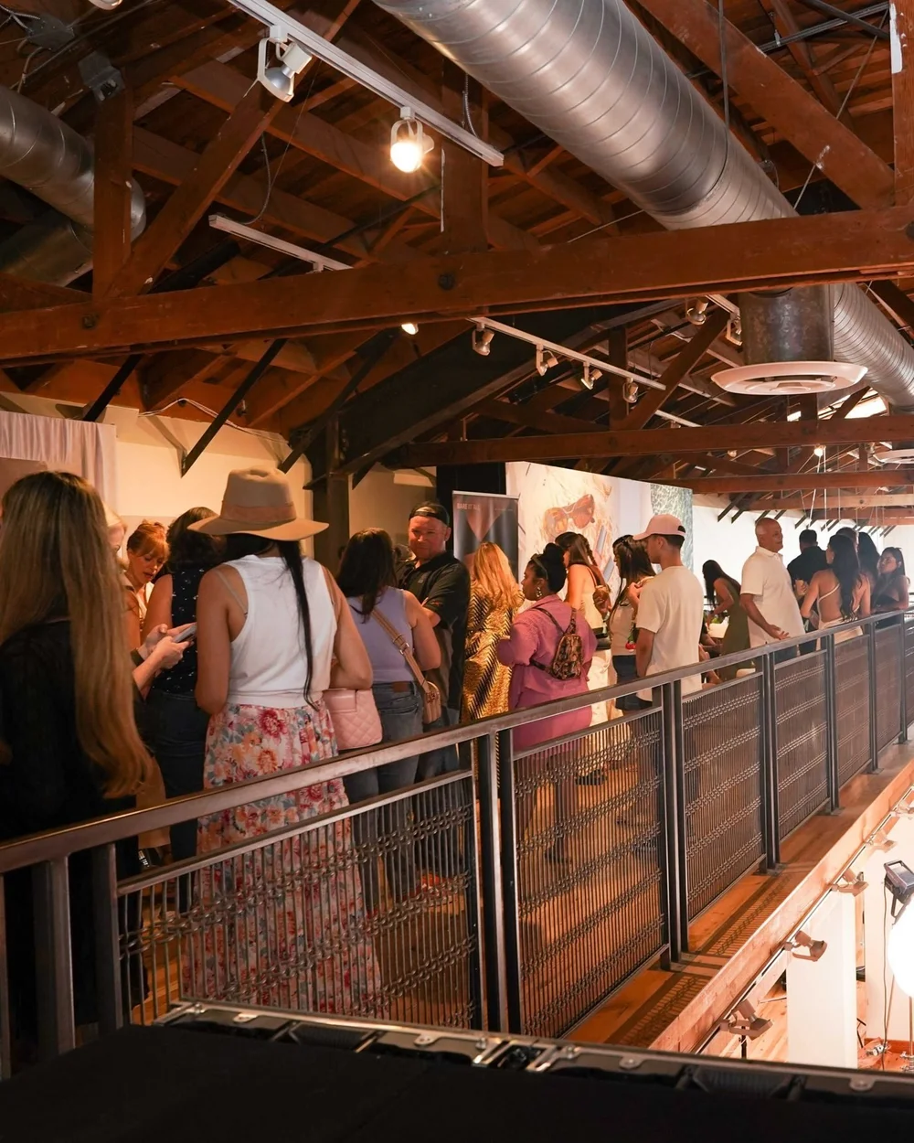 A packed room of creators at the launch party, seen from the mezzanine