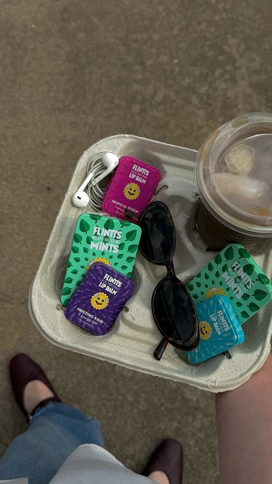 Mint and lip balm tins in a coffee carrier