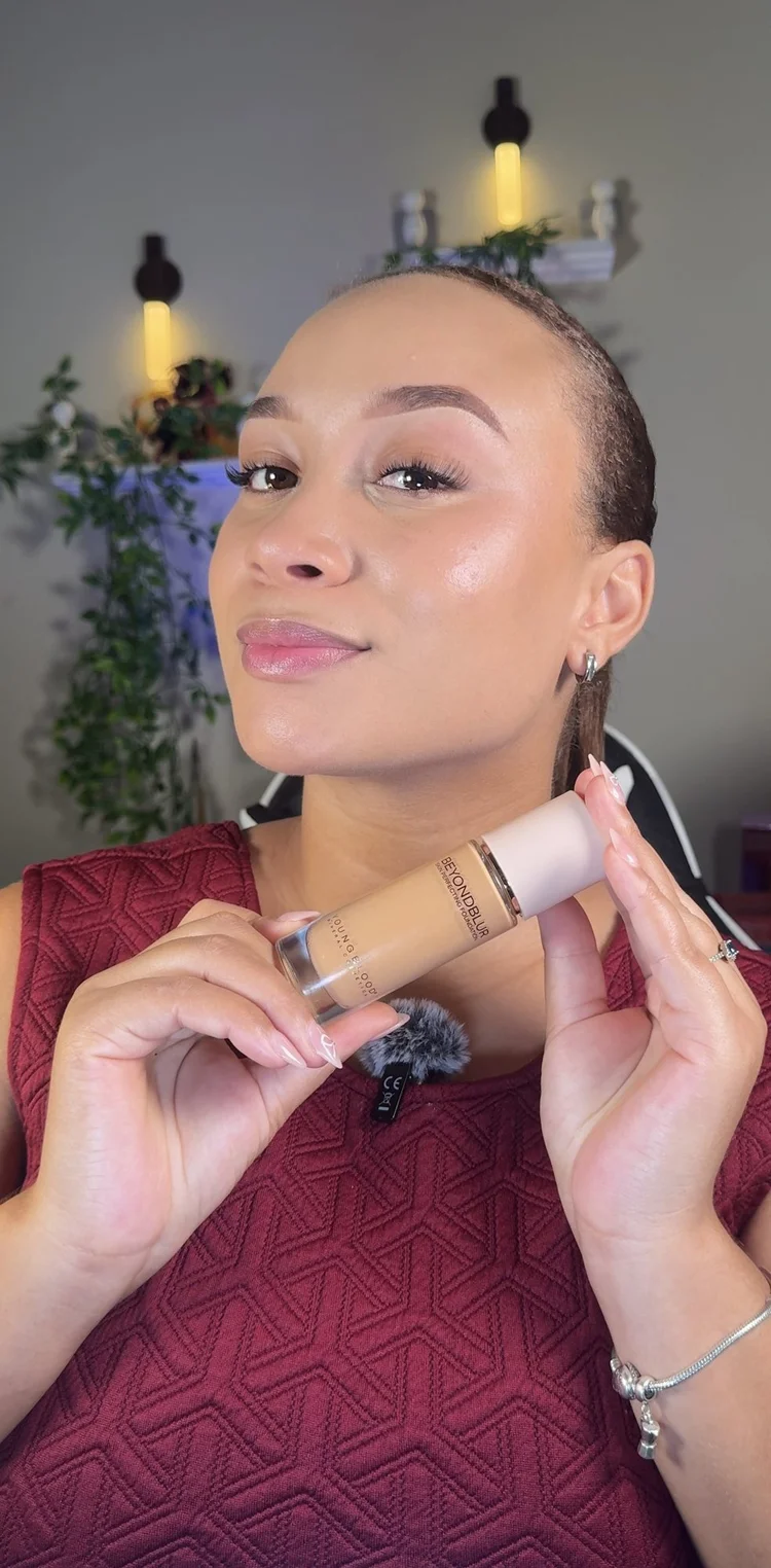 A creator holding a bottle of BeyondBlur foundation