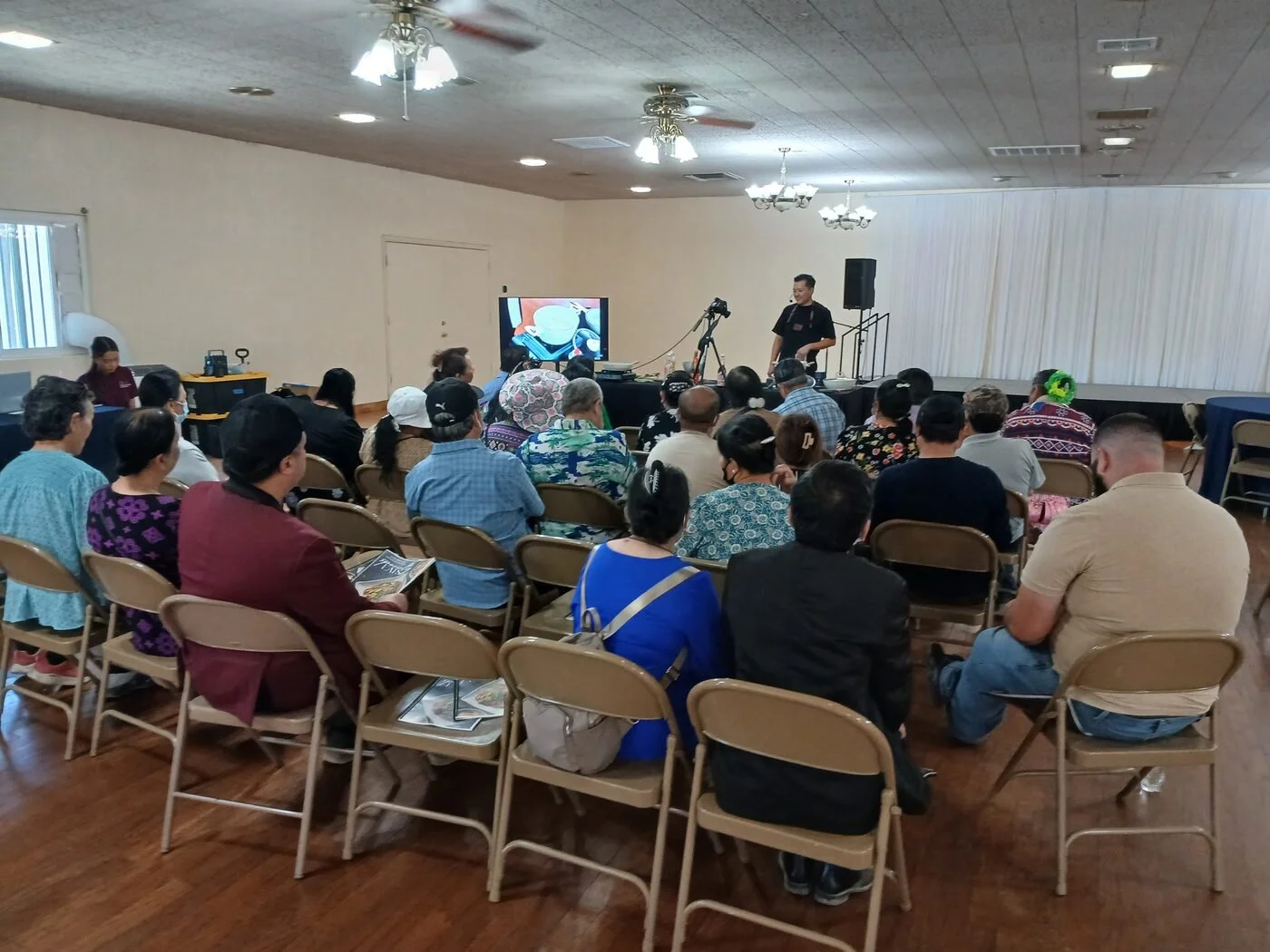 Community members attending a live cooking food demonstration