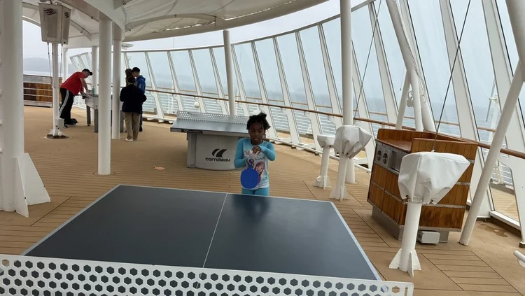 Piper Bryan playing ping pong on the deck of a Disney cruise in Alaska