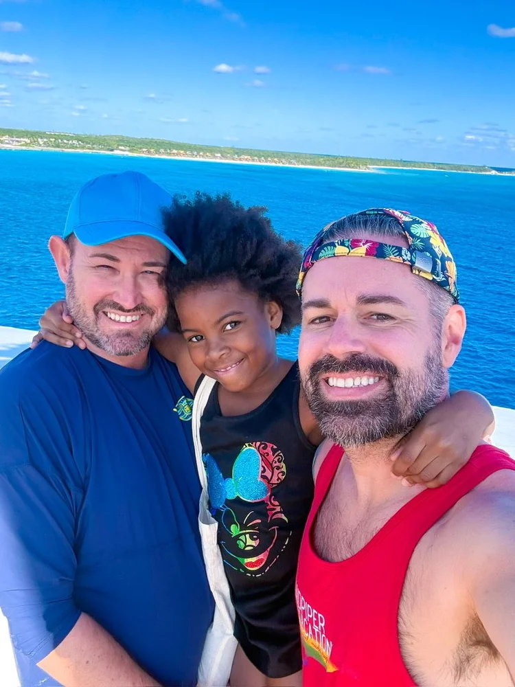 Piper Bryan with her dads Sean and Nick on a Disney cruise