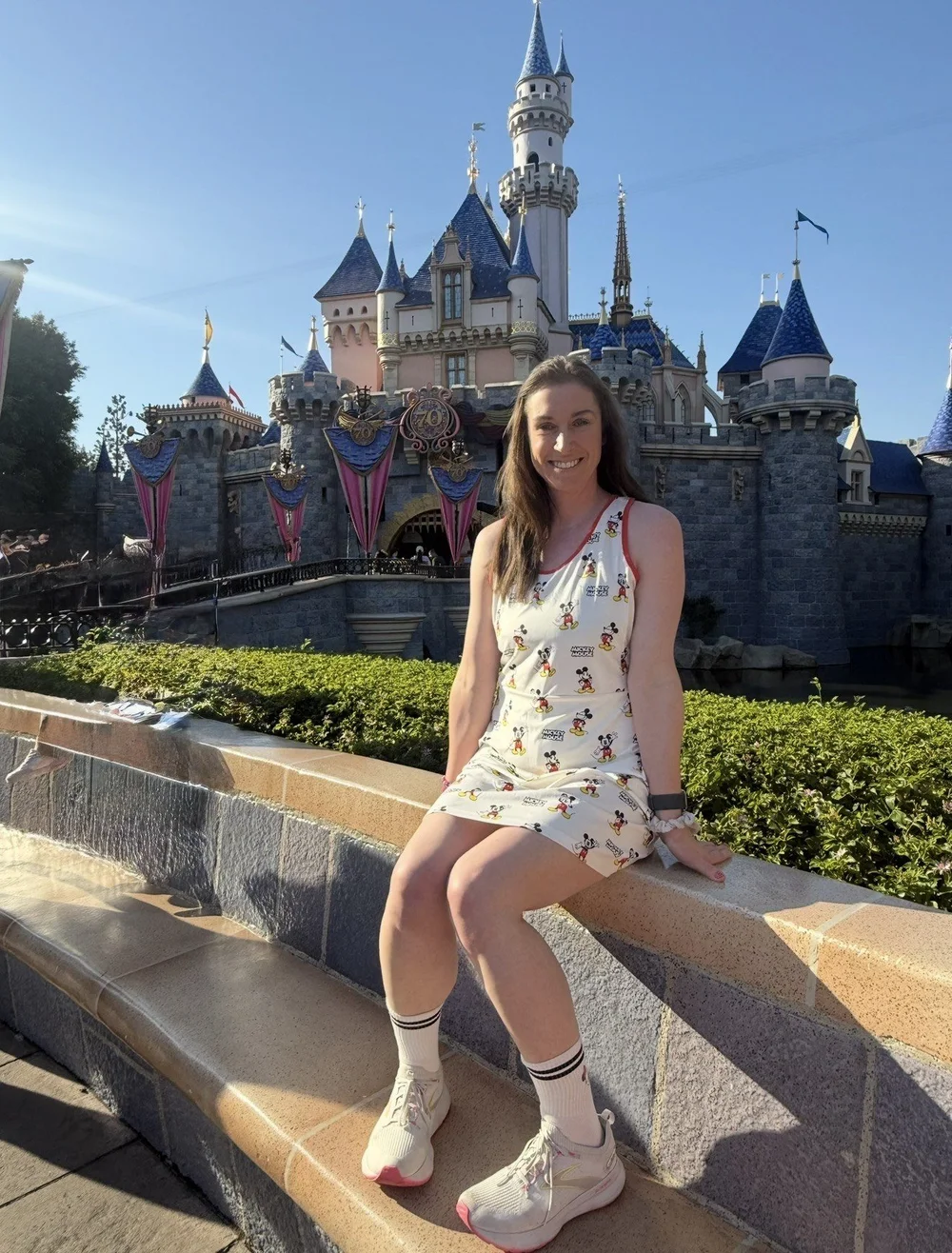 Danielle Casey, Travel Advisor with Sandpiper Vacations, in front of Sleeping Beauty Castle at Disneyland