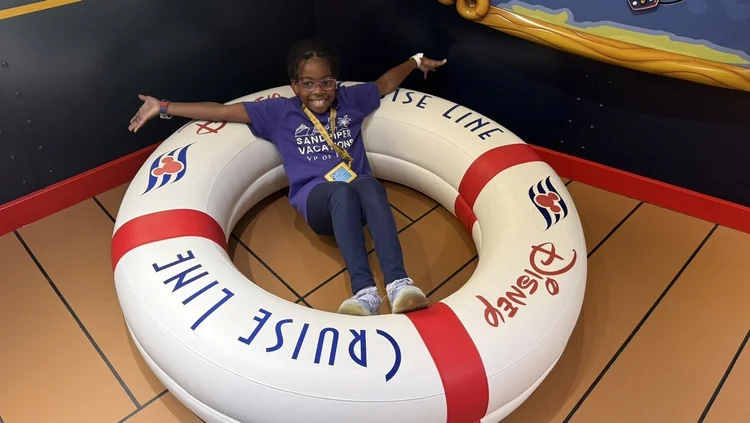 Piper Bryan in her VP of Fun shirt inside a Disney Cruise Line life ring