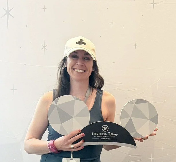 Danielle Casey holding EarMarked by Disney Silver Level ears