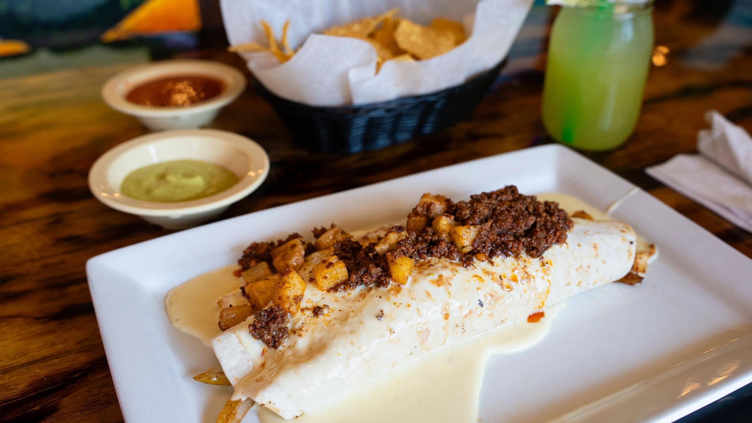 Hearty burrito smothered in queso and chorizo
