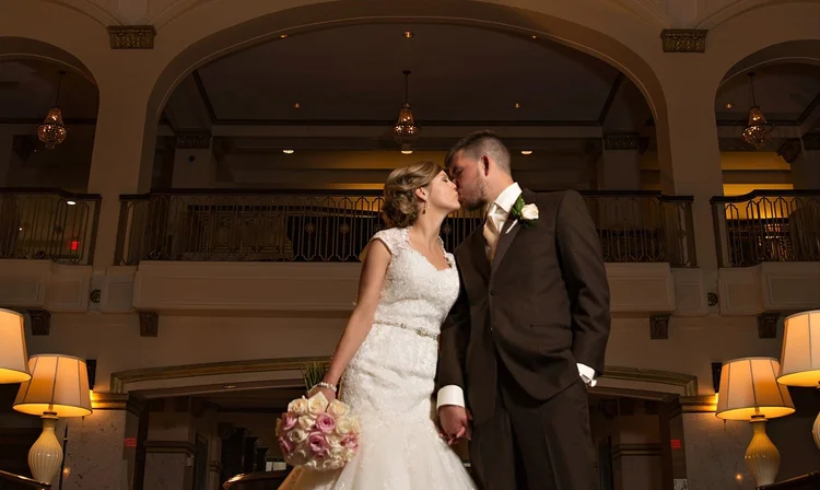 Bride and groom kiss in the Grand Lobby