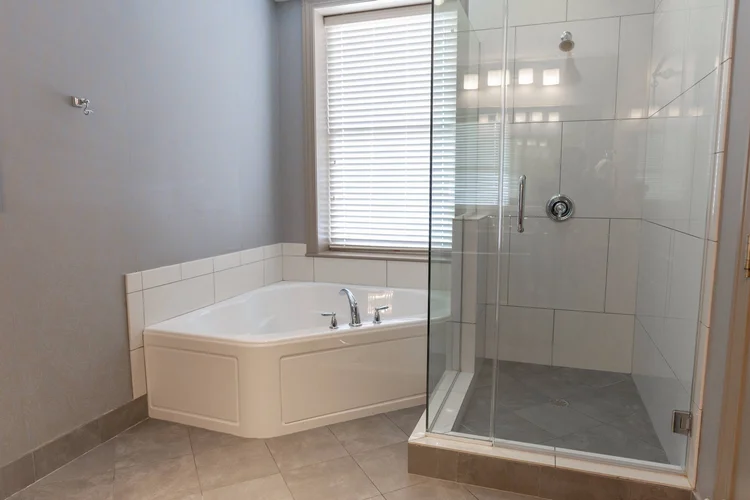 Jacuzzi tub and glass walk-in shower in the Jacuzzi King room