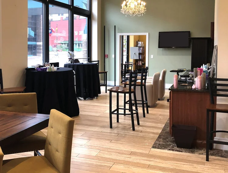 Bridal ready room with high-top tables and a vanity bar