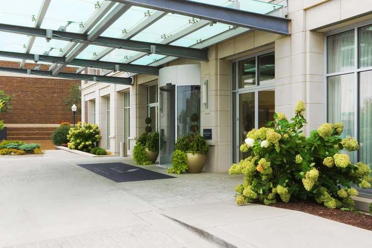 Hotel Blackhawk's porte cochere entrance with hydrangeas and a revolving door