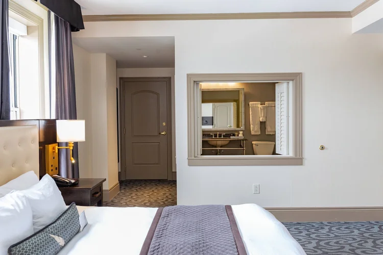 Jacuzzi King guest room with a window into the bathroom