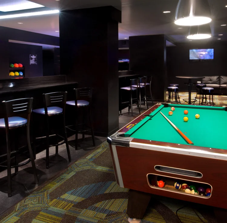 Blackhawk Bowl lounge with a pool table, high-top tables and a bar