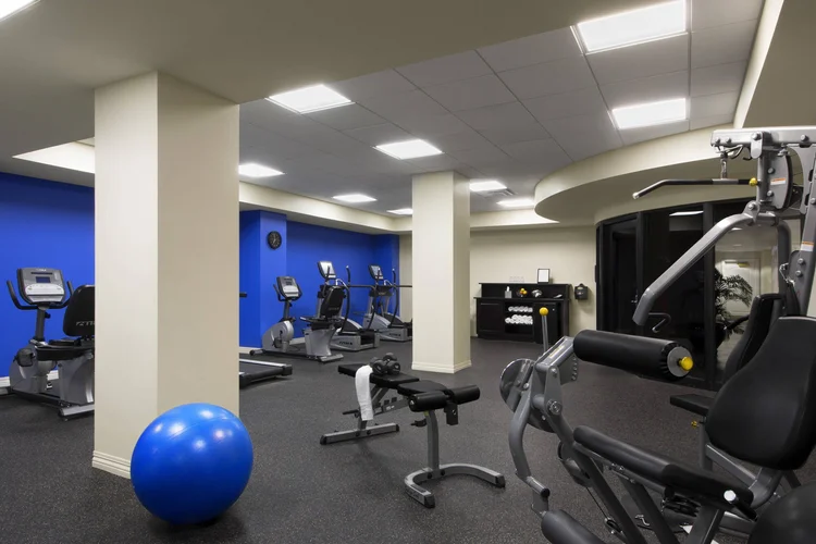 24-hour fitness center with cardio machines, weight equipment and an exercise ball