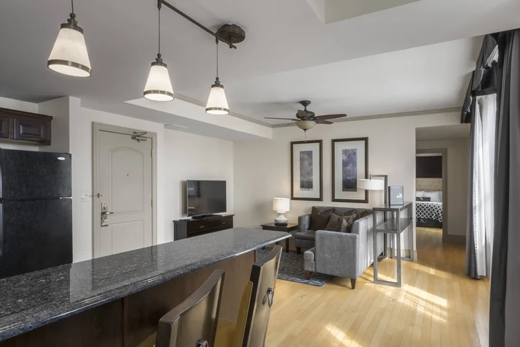 Two-Bedroom Suite with a kitchen counter, living room and hardwood floors