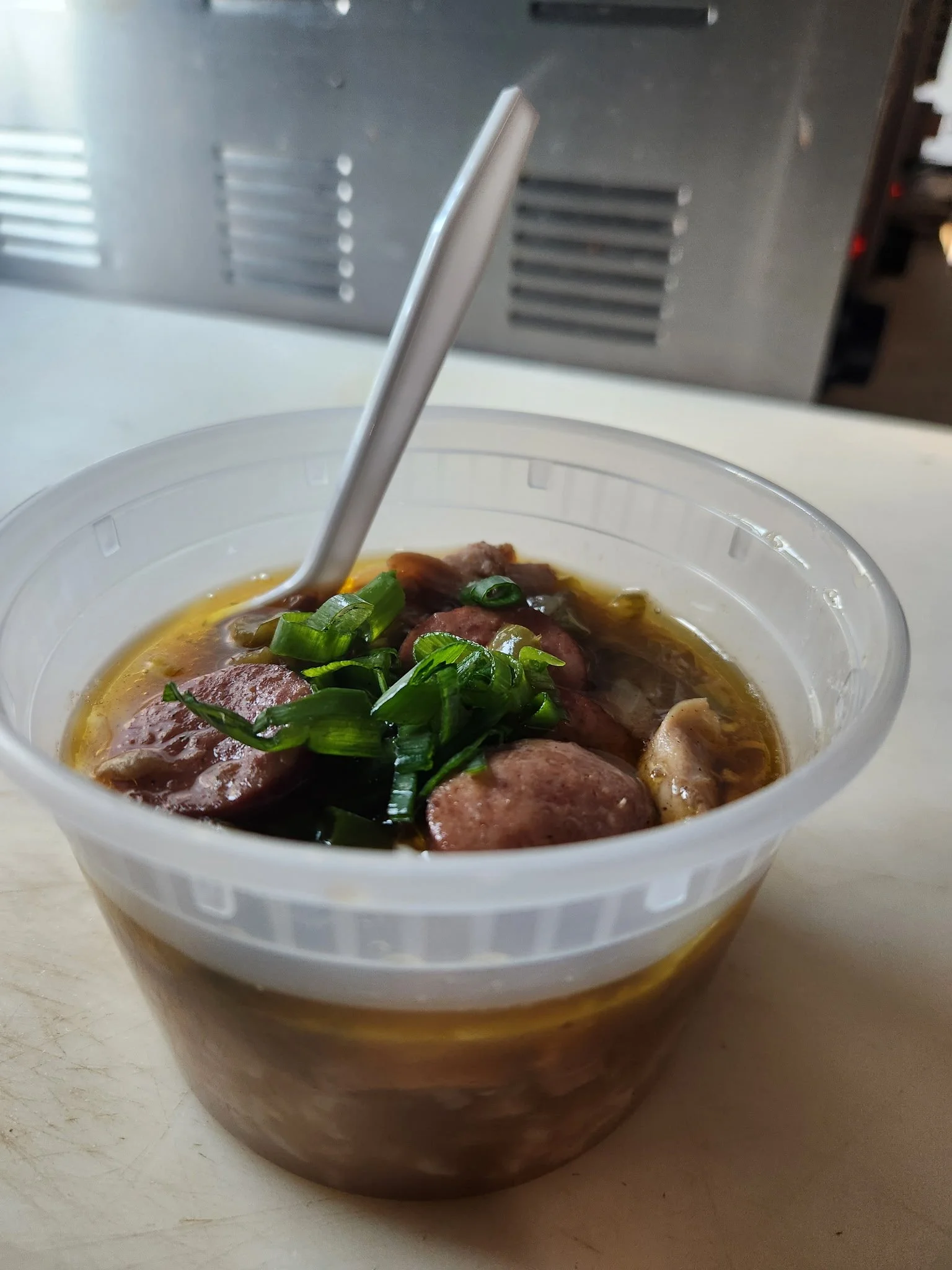 Chicken and sausage gumbo topped with green onions