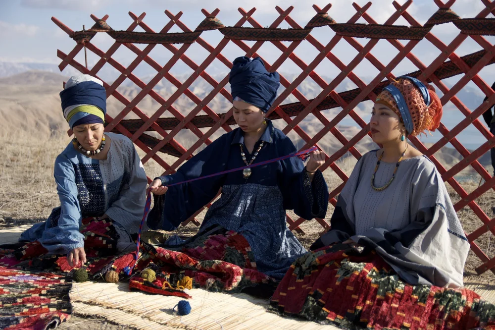Kyrgyz women in a yurt with hand-embroidered textiles