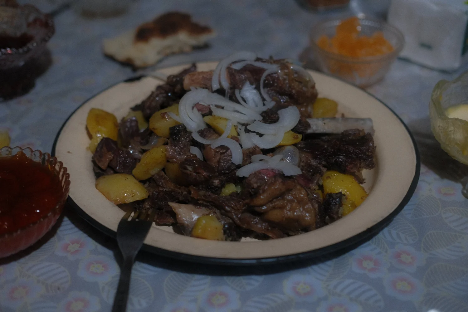 A family supper of fried meat, potatoes and onion