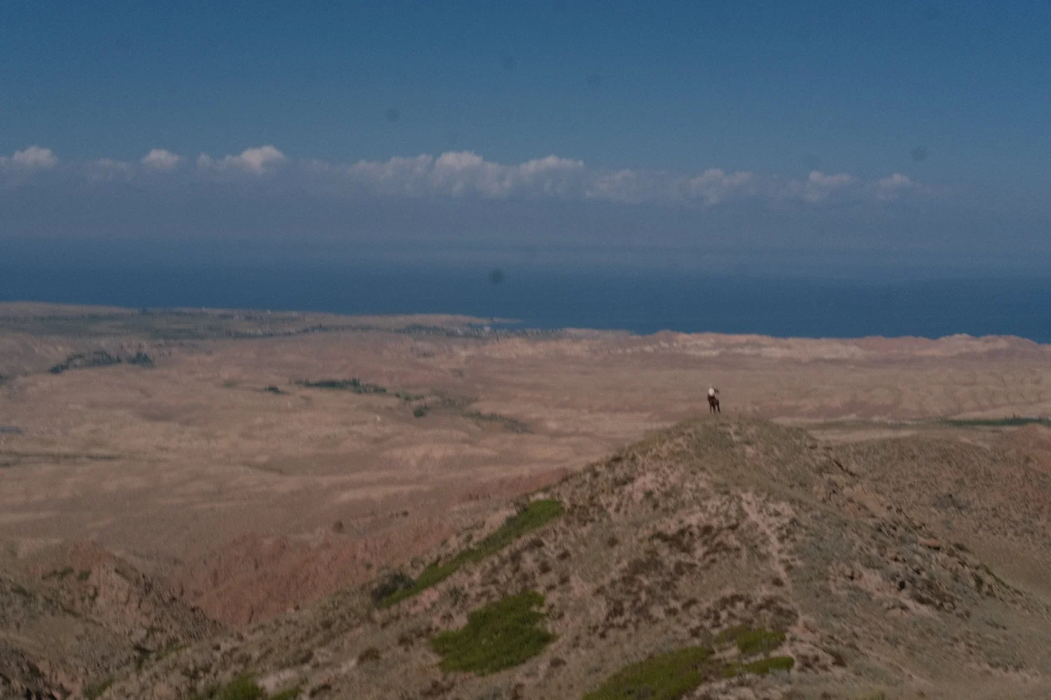 The deep blue of Issyk-Kul seen from the dry hills of its southern shore
