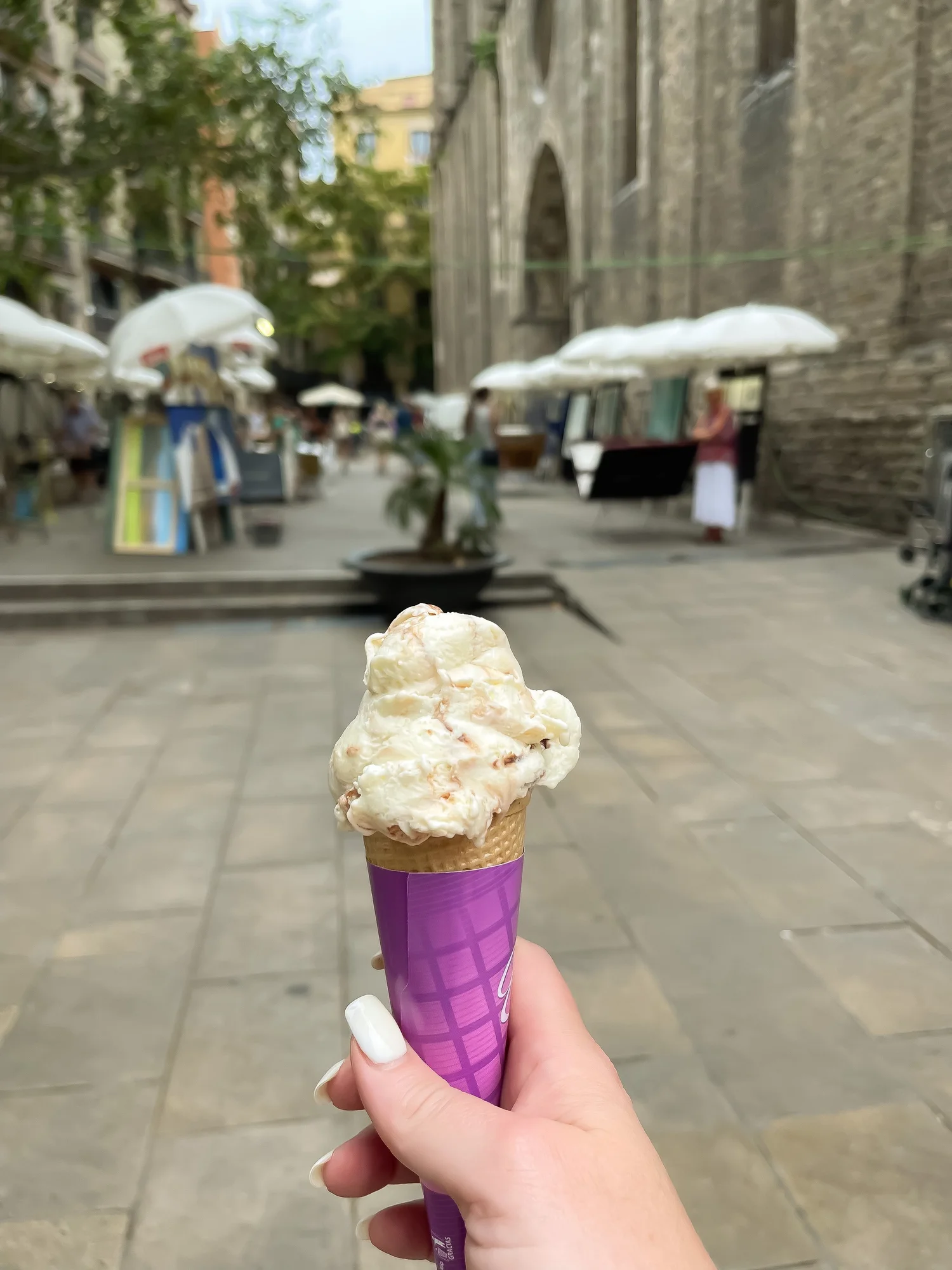 Gelato held on a pedestrian street in Barcelona