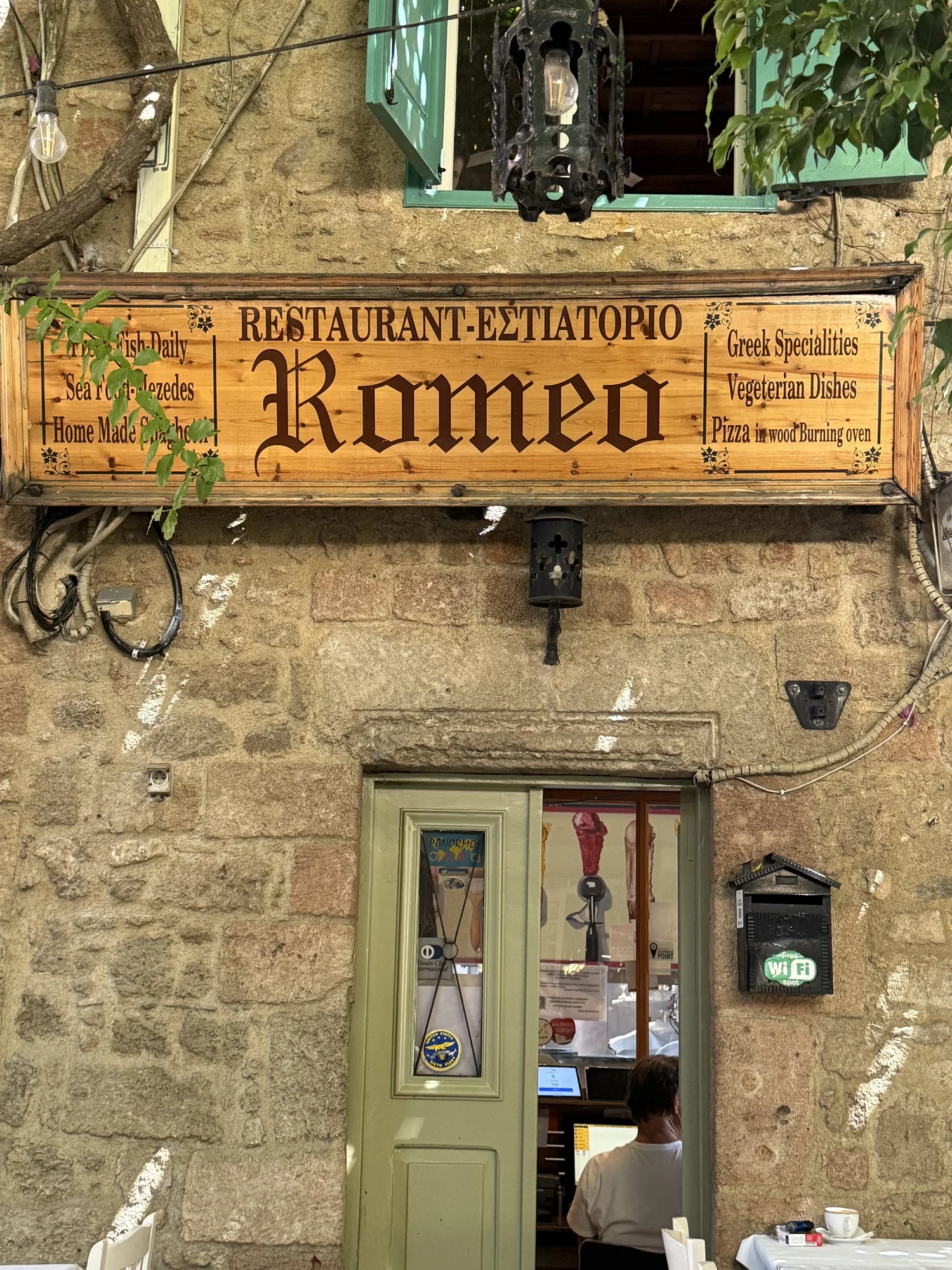 Traditional Greek restaurant exterior on a stone street
