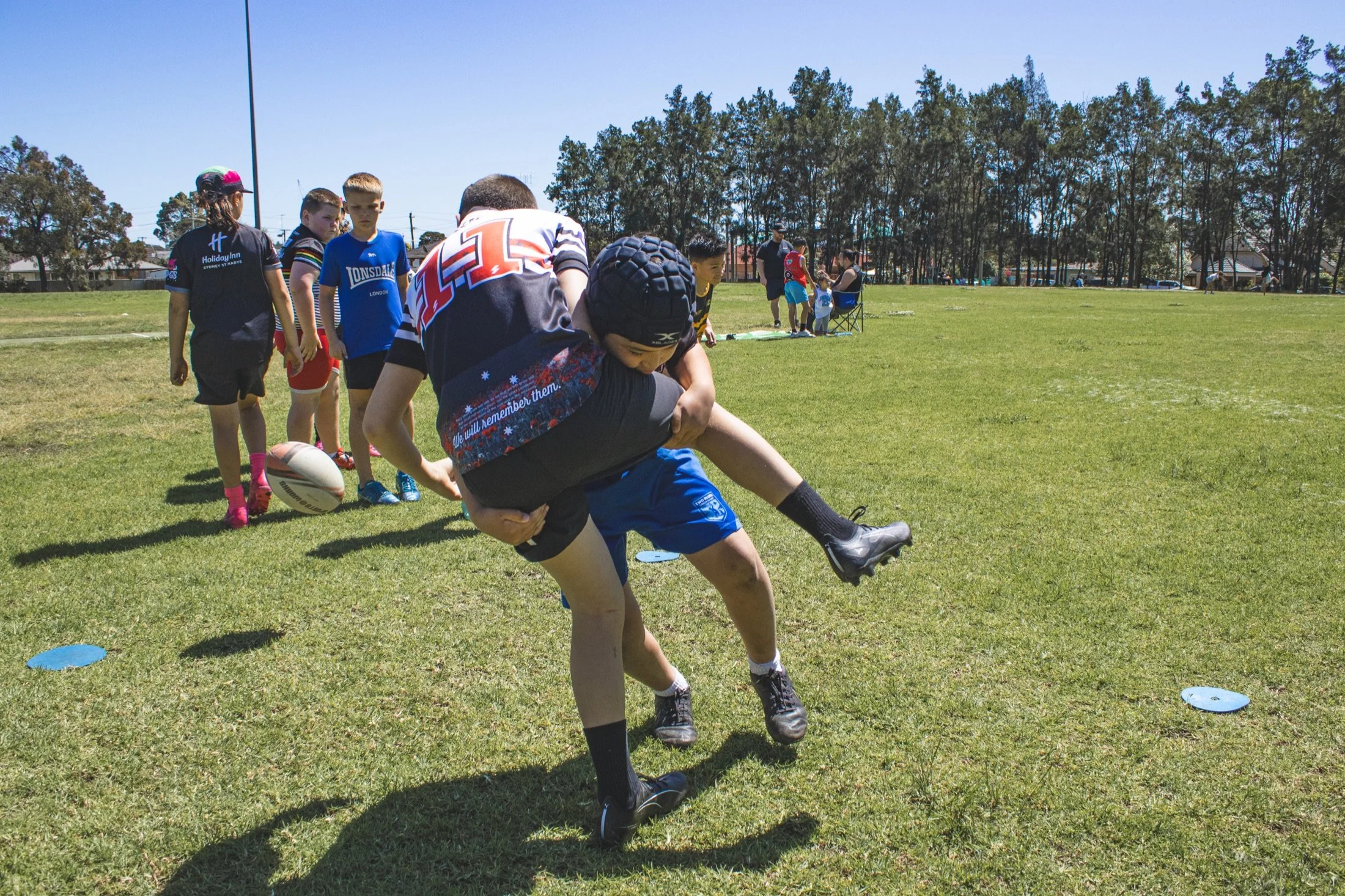 Junior S2S player preparing to pass a rugby ball