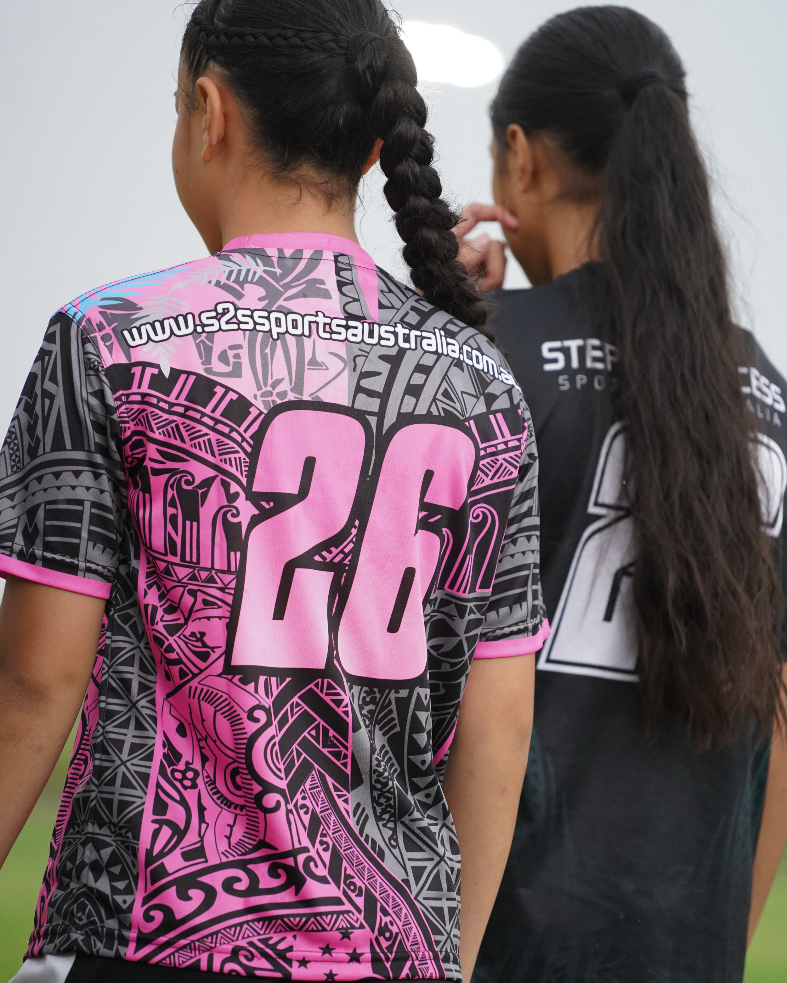 S2S players together, wearing pink and charcoal training shirts