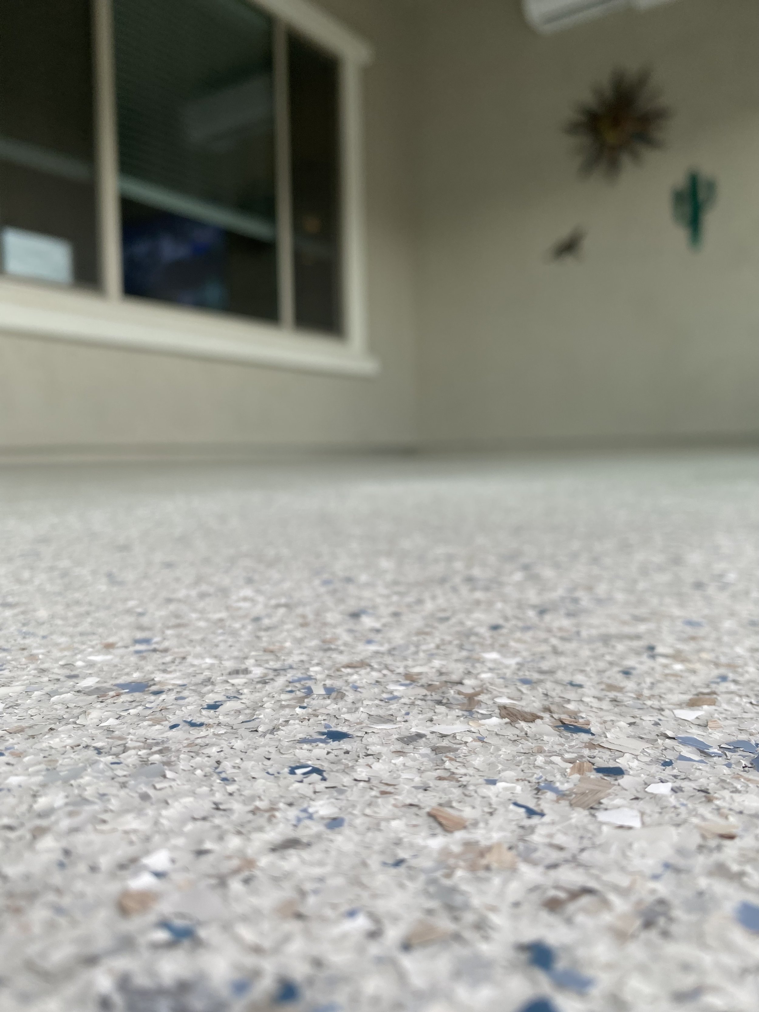 Close-up of a full broadcast hybrid flake epoxy floor