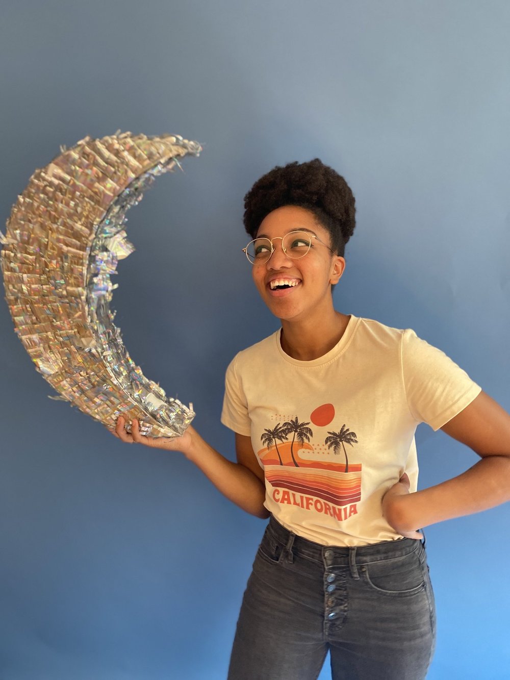 Chelsy DeHart, who leads Sunday School and Youth Corp, holding a handmade paper moon