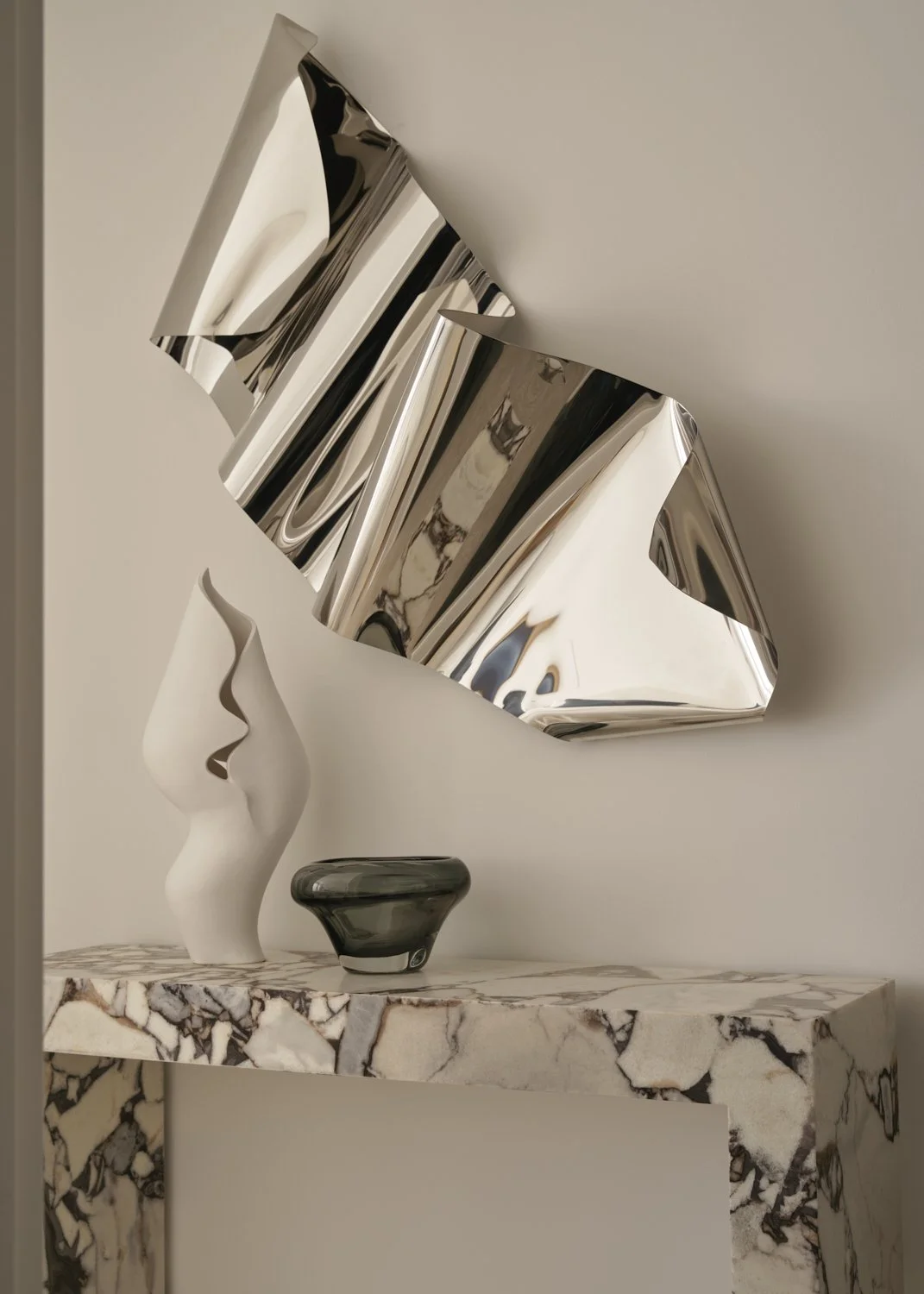 Potts Point apartment styling, chrome stainless steel wall sculpture on marble console by Rory James Carter