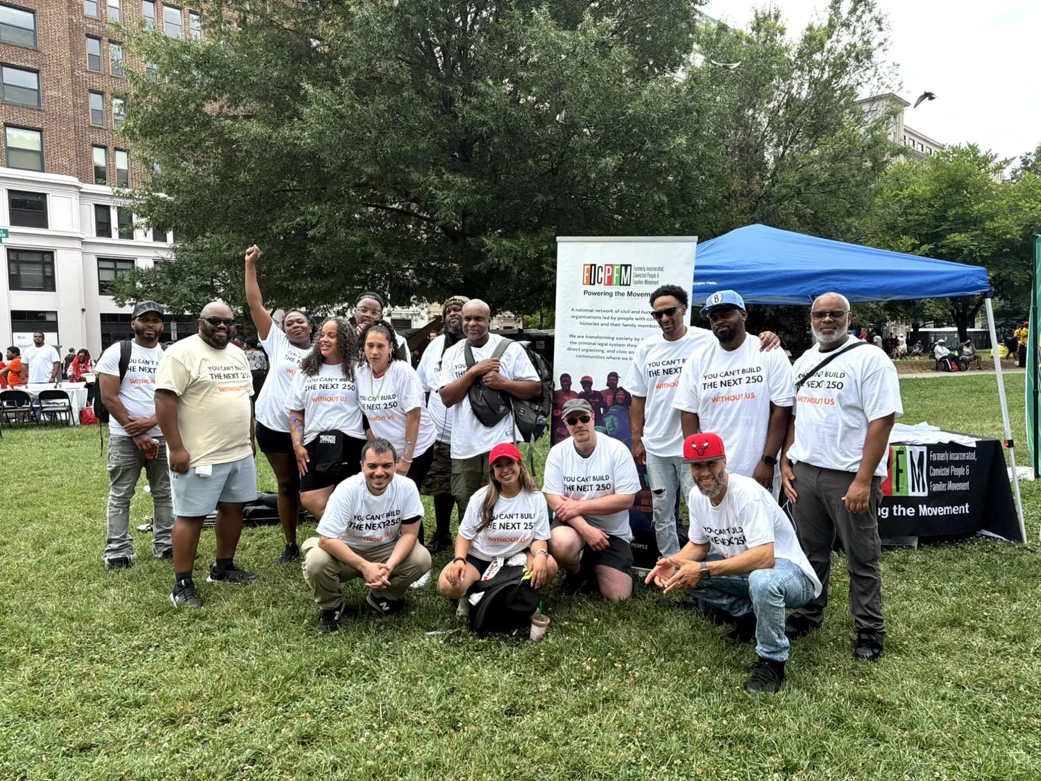 A large group of FCC members and supporters posing together outdoors