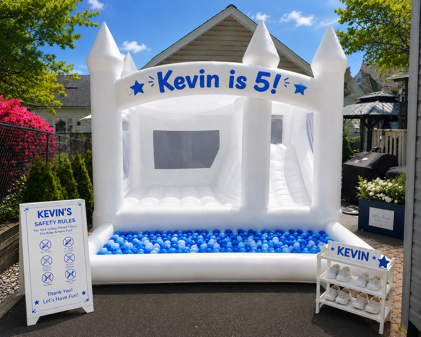 Deluxe white bounce house package with balloon garland