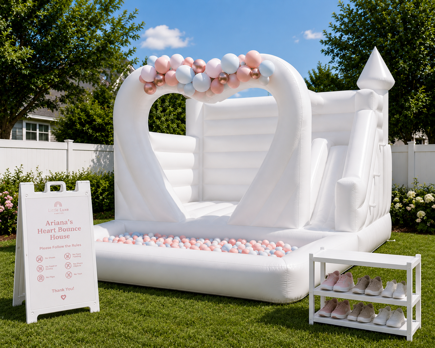 Deluxe heart bounce house package with balloon garland