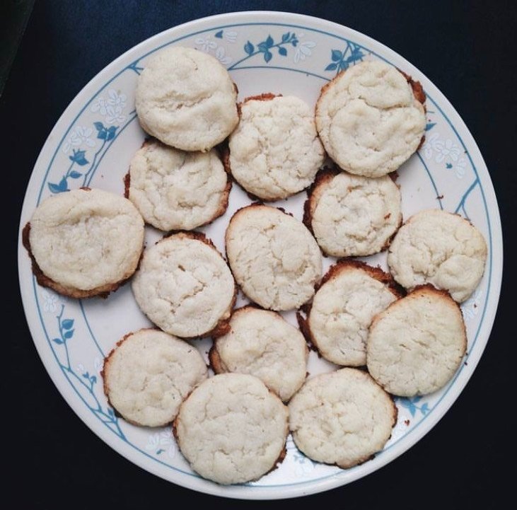 Picture of white cookies with brown edges on a white and blue plate taken from above. 